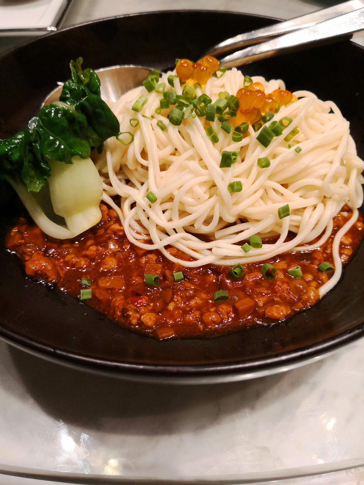 Hand-pulled noodles with spicy minced pork, cod roe, chopped spring onions and seasoning.